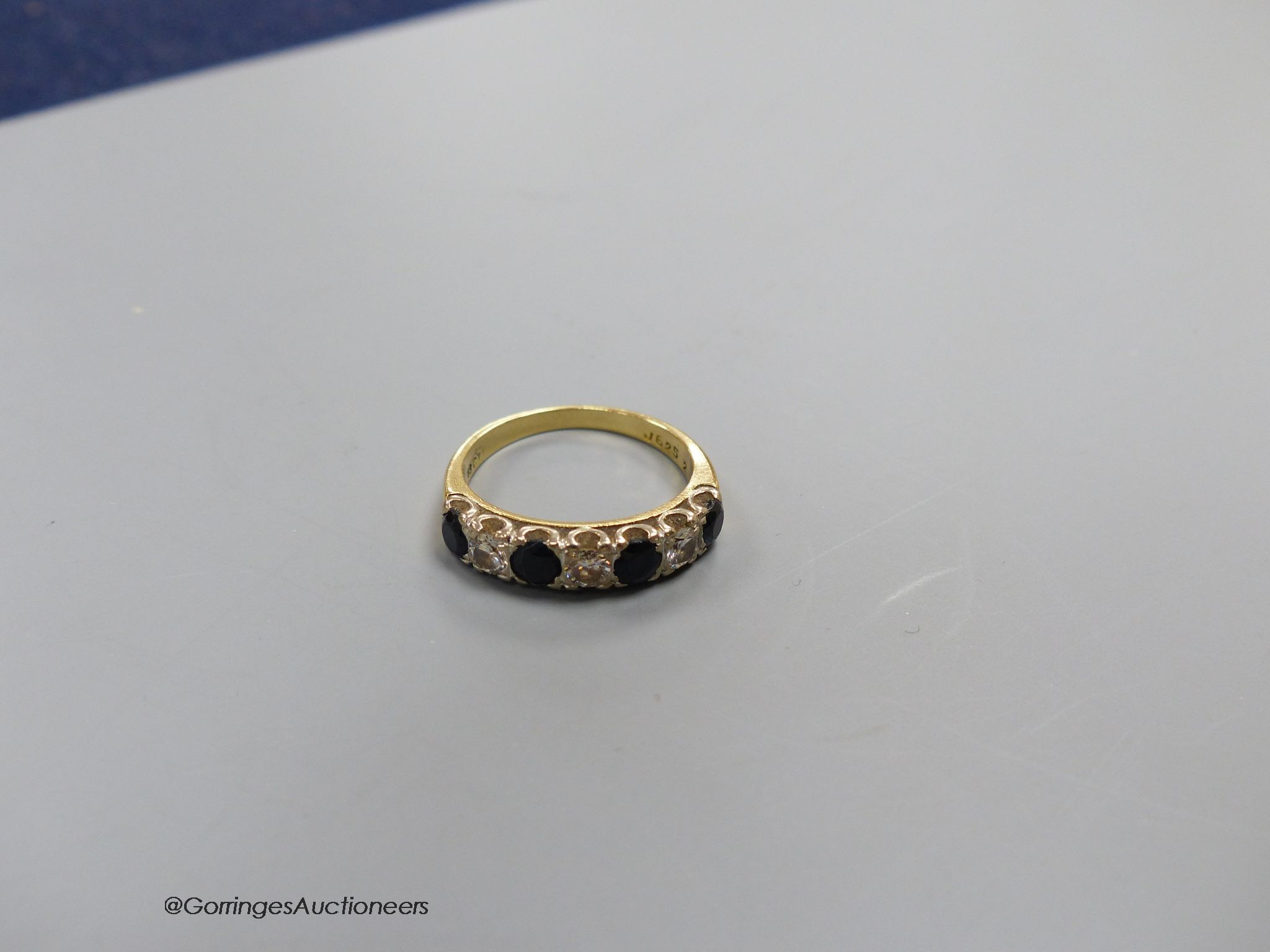 An 18ct gold sapphire and diamond seven stone ring, size N, gross 4g.